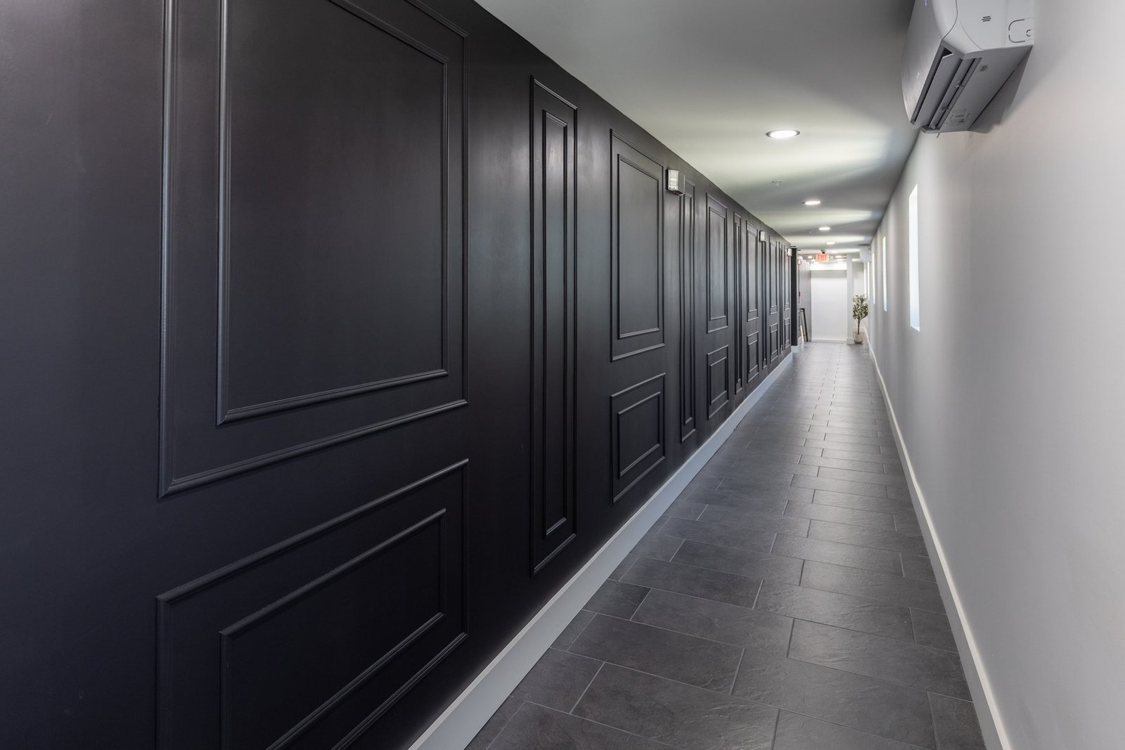 Dramatic motel corridor with black panel walls