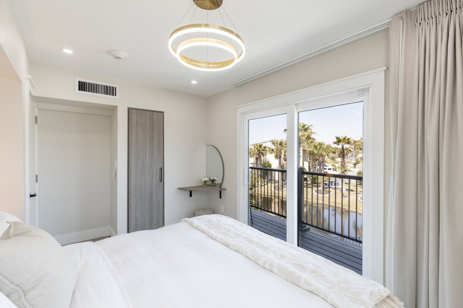Bedroom with private balcony and palm views